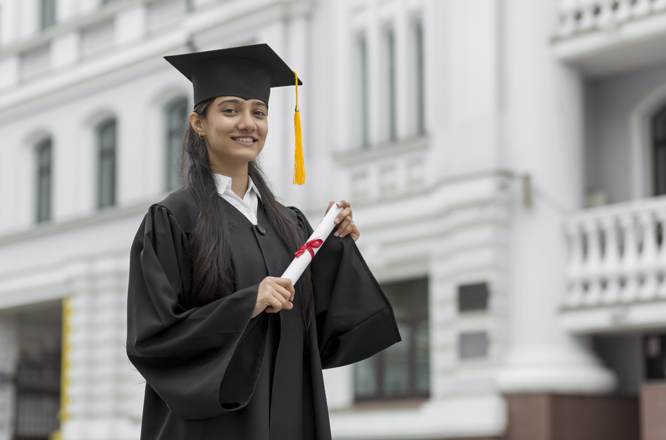 girl holding a degree