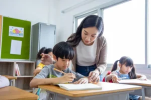 Primary school pupils learning with a teacher in a Singapore classroom